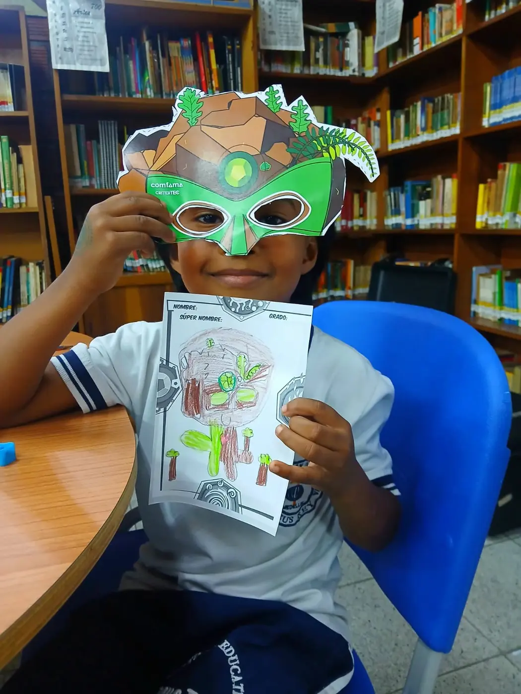 Un niño con su máscara y el dibujo de su superhéroe